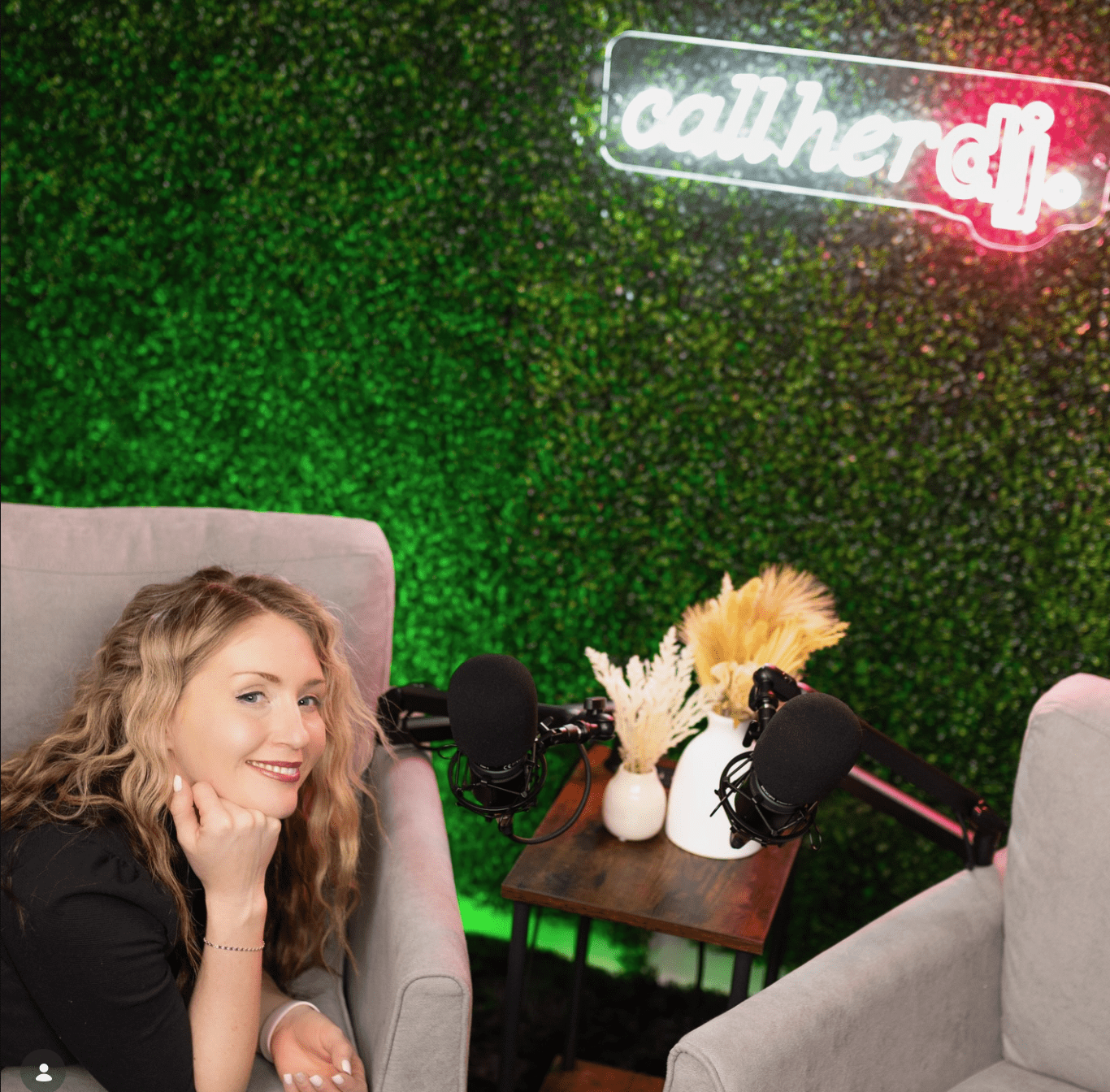Abby in the Call Her DJ podcast studio with neon signage and microphone