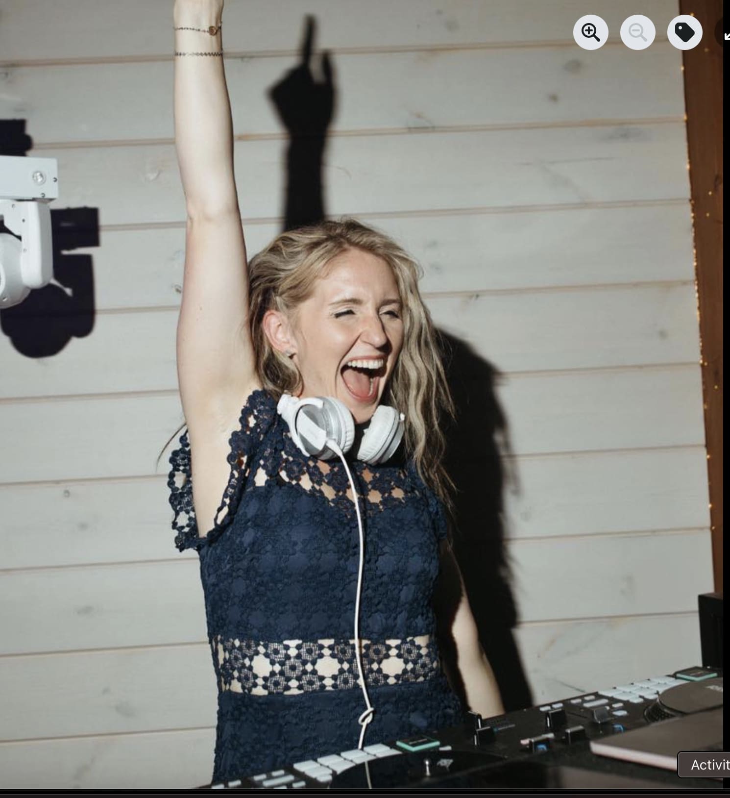 DJ Abby Rodriguez performing live with fist raised in celebration